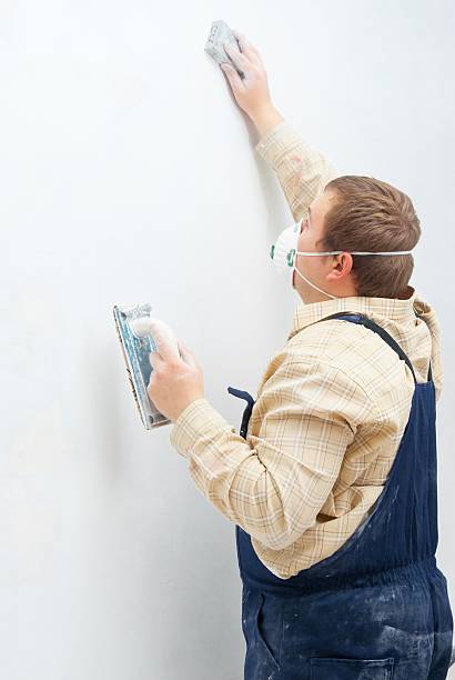 istock Young man builder polishing the wall 176906857