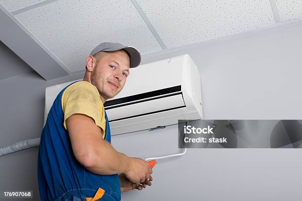 Installer Sets A New Air Conditioner Stock Photo - Download Image Now - Air Conditioner, Technician, Installing