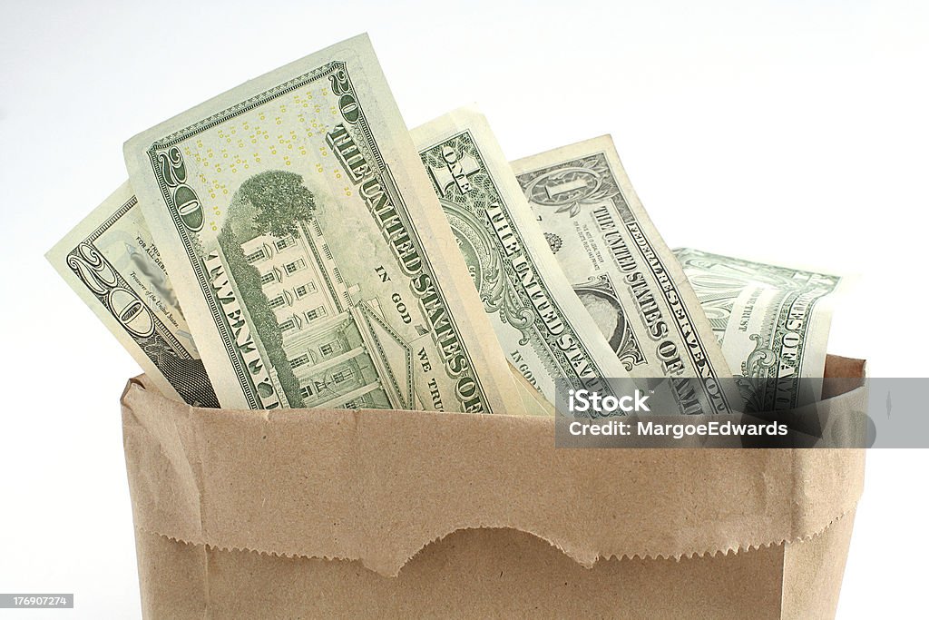 Bagful of money Business corruption or kickback concept of bagful of cash Paper Bag Stock Photo