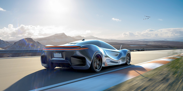 A generic blue electric sports car viewed from behind moving at high speed along the straight of a racetrack in a fictional location, surrounded by hills and mountains under a bright blue sky. With motion blur to track, wheels and background. Visible lensflare.