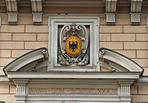 Coat of arms of Austria as Eagle bronze statue in Salzburg of Austria, in Europe. Colorful figurine on white background.