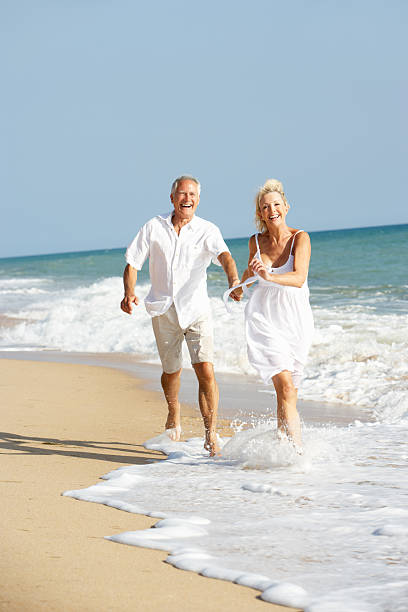 istock Senior Couple Enjoying Beach Holiday 176907564