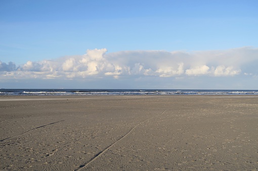 On the beach of the Dutch island Schiermonnikoog there are white clouds on this sunny but windy fall day.