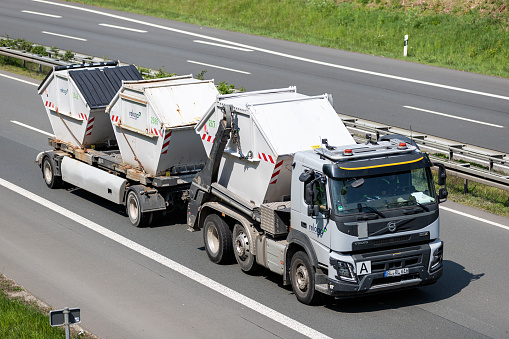 Wiehl, Germany - May 3, 2022: Reloga Volvo FMX roll-off conatiner combination truck on motorway