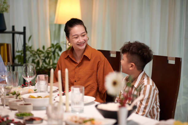 istock Mother Taking to Kid at Dinner Table 1769088371