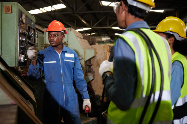 istock male african foreman training and teaching how to use machine control with workers in factory 1769089560