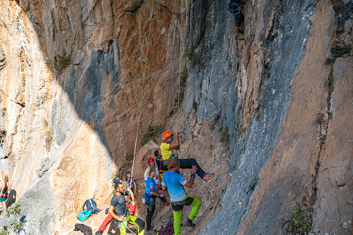 Olympos, Antalya, Türkiye-October 29, 2023:rock climber teachers are helping kids on the amazing walls of the rock mountain in Olympos, Antalya, Turkey