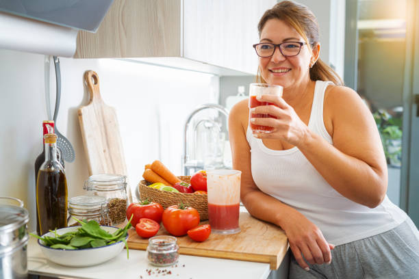 istock Woman drinking freshly blended tomato juice in her kitcen 1769128630
