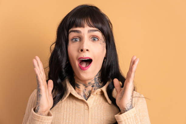 istock surprised woman raising arms and celebrating 1769143309