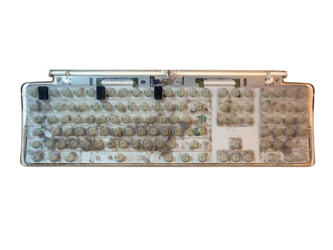 Dirt and dust on disassembled old computer keyboard without keycaps top view isolated on white