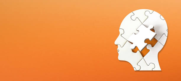 istock Brain shaped white jigsaw puzzle on colored background. Mental health and problems with memory. 1769156514