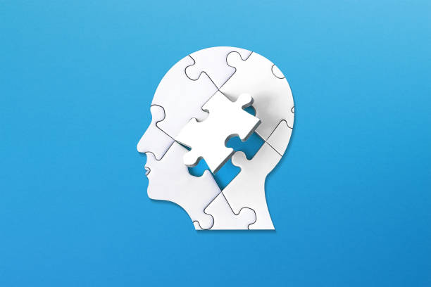 istock Brain shaped white jigsaw puzzle on colored background. Mental health and problems with memory. 1769156516