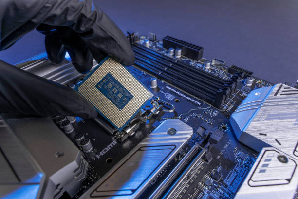istock computer processor in a gloved hand against the background of the motherboard 1769166746