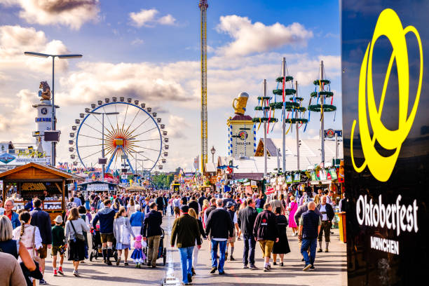 Munich, Germany - September 24: people, typical souvenir stands, sale booths, fairground rides and decoration at the Oktoberfest in Munich on September 24, 2023