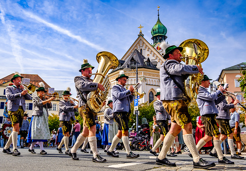 Rosenheim, Germany - September 3: participants at a typical bavarian thanksgiving parade with brass band and traditional clothes in Rosenheim on September 3, 2023