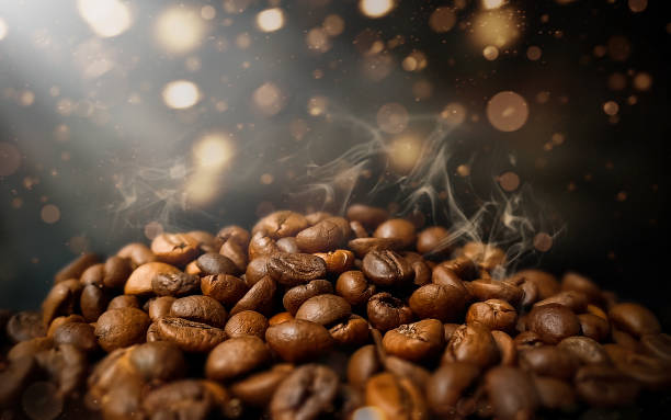 istock Brown roasted hot coffee beans on dark background 1769176531