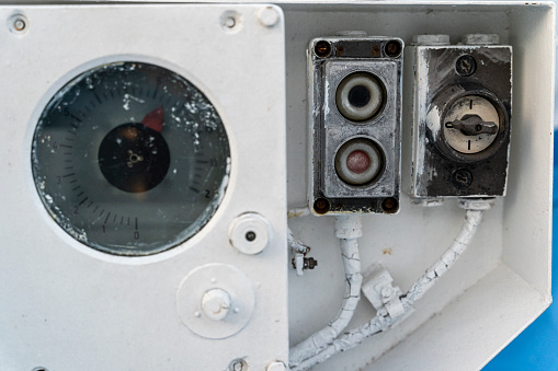 Electric deck control panel for lifting and lowering the anchor chain. Key and control buttons of the anchor winch, Arrow pointer close-up