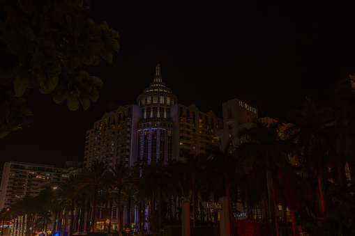 Florida. USA. 11.01.2023. Beautifil view of exterior of Sant-Moritz Hotel on very dark evening in Miami Beach.