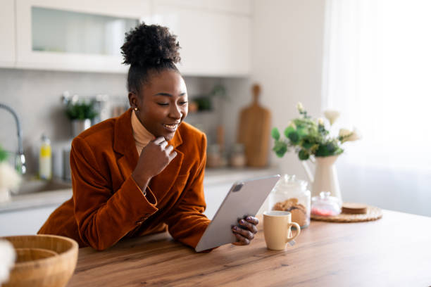 istock Young woman looking at tablet pc with hand on chin 1769198084