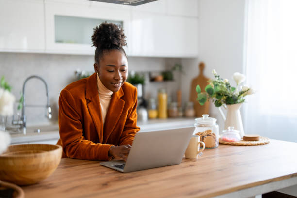 istock Confident businesswoman doing research over wireless computer on desk while sitting in home office 1769198093