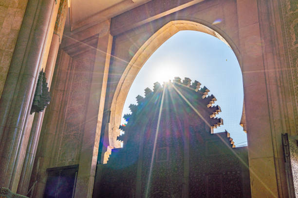 White pavilion with Moorish arches and green tiles in Tetouan, elegant architecture standing out against a calm, clear sky.