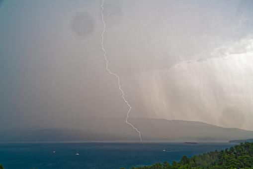 thunder in heavy rain on island nearby