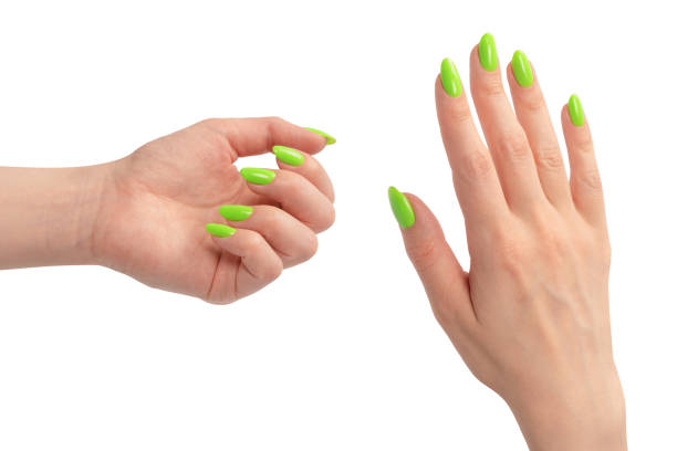istock Hand of a woman with green naols hold some tiny or thin object. 1769232910