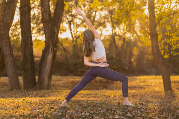 istock Woman practicing yoga pose in the autumn park 1769260775