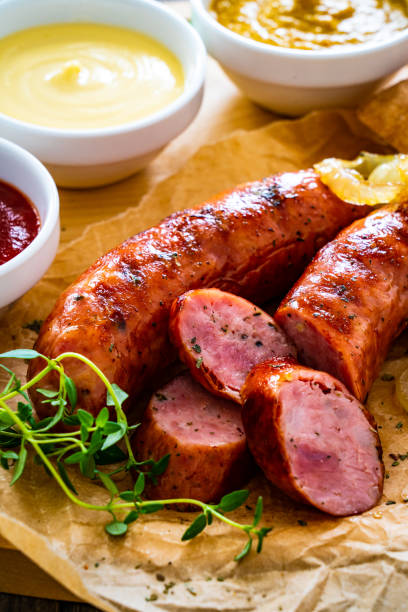 istock Fried sausages and vegetables on wooden table 1769268279