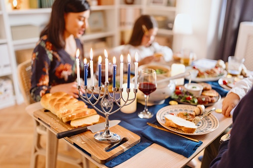 Close-up picture of Menorah and a dining table during Hewish Holidays