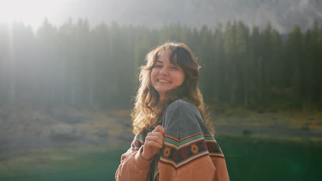 Woman on the background of Lago di Carezza in autumn