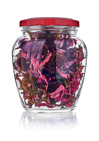 Dried echinacea flowers in jar isolated on white. Used for anti-inflammatory tea in conventional and alternative medicine, including homeopathy.