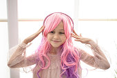 Vanilla Girl. Kawaii vibes. Little girl with pink hair have party. Listening music with headphones, mobile phone.