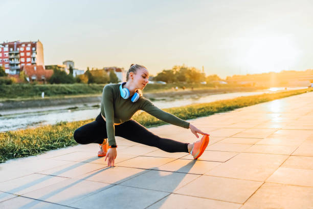 istock Sporty woman warming up and stretching before running 1769305178