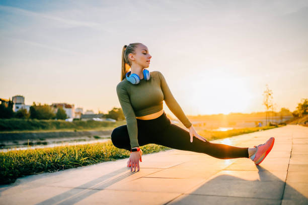 istock Sporty woman warming up and stretching before running 1769306872