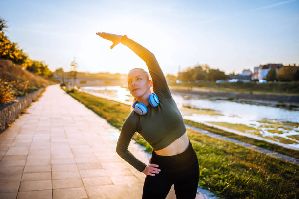 Woman doing morning exercises outdoors in the park