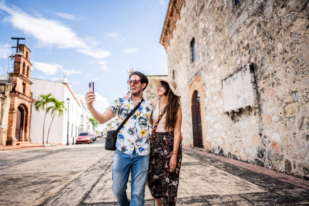 istock Tourist couple taking a selfie or filming using mobile phone in historic district 1769311976