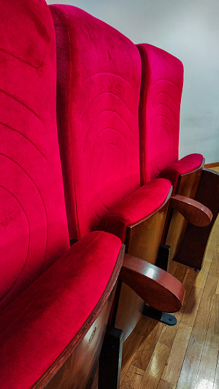 red seats to see a performance in a music or performance theater with selective focus
