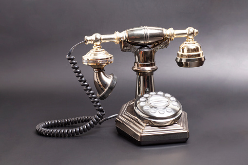 Vintage telephone on black background
