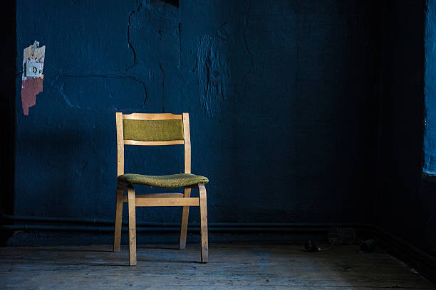 istock Wooden chair against deep blue wall 176937011