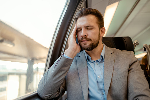 Anxious Man With a Headache Commuting on Train