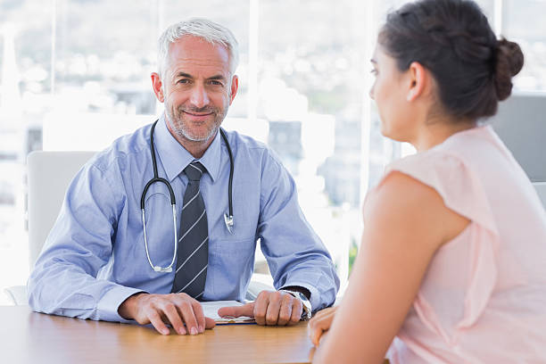 istock Attractive doctor sitting in front of patient 176937194