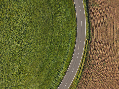 Aerial view of a road between fields in the landscape