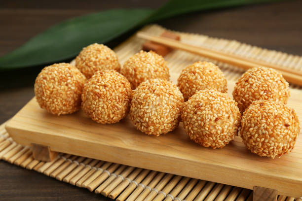 istock Many delicious sesame balls on wooden table, closeup 1769399048