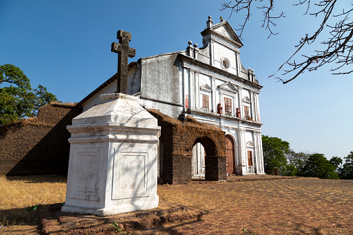 This image features the historic churches of Old Goa, a UNESCO World Heritage Site known for its well-preserved examples of religious architecture dating back to the Portuguese colonial era. The churches, such as the Basilica of Bom Jesus and the Se Cathedral, stand as majestic landmarks with intricate facades, large courtyards, and imposing towers. The photograph aims to capture the grandeur and architectural finesse of these religious edifices, while also shedding light on their historical significance. Through the lens, viewers get a sense of both the spiritual and cultural importance these churches hold, serving as both tourist attractions and places of worship that have stood the test of time.