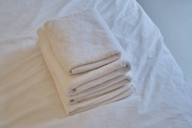 istock A stack of clean white towels on the bed. Hotel service. Place for text 1769411637