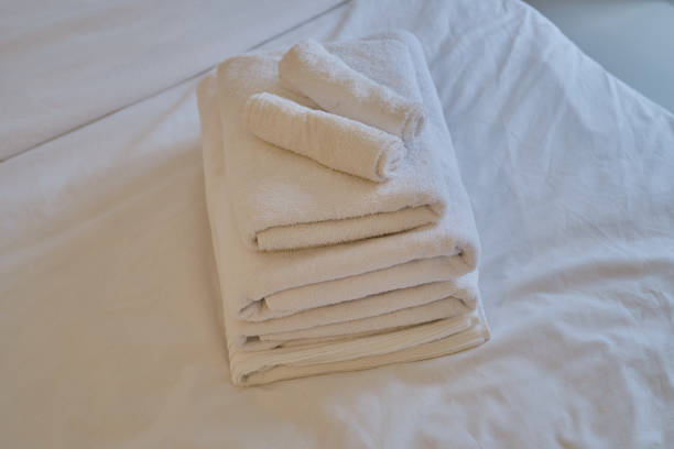 istock A stack of clean white towels on the bed. Hotel service. Place for text 1769412173