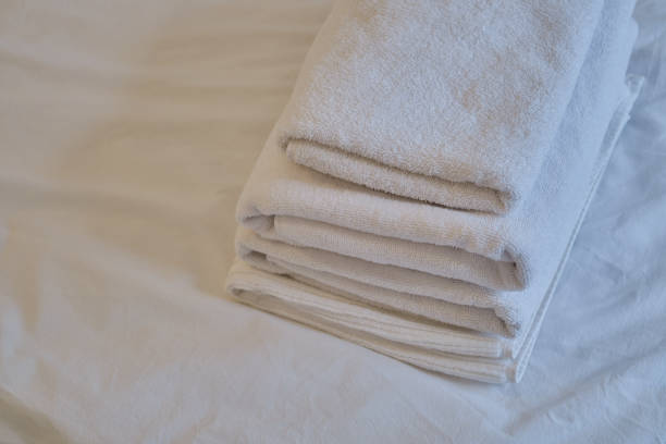 istock A stack of clean white towels on the bed. Hotel service. Place for text 1769412178