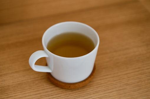glass of hot tea on white background