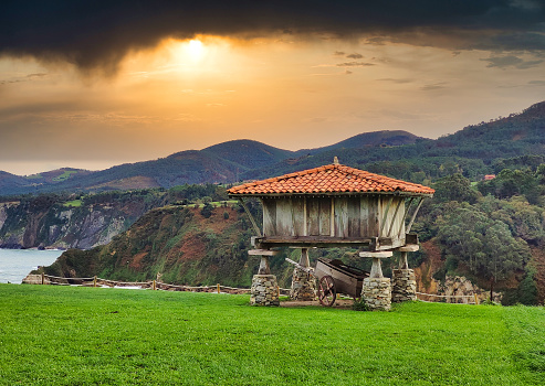 Hórreo, cabaña típica de Asturias, junto a la capilla de La Regalina, Cadavedo, Asturias, España photo